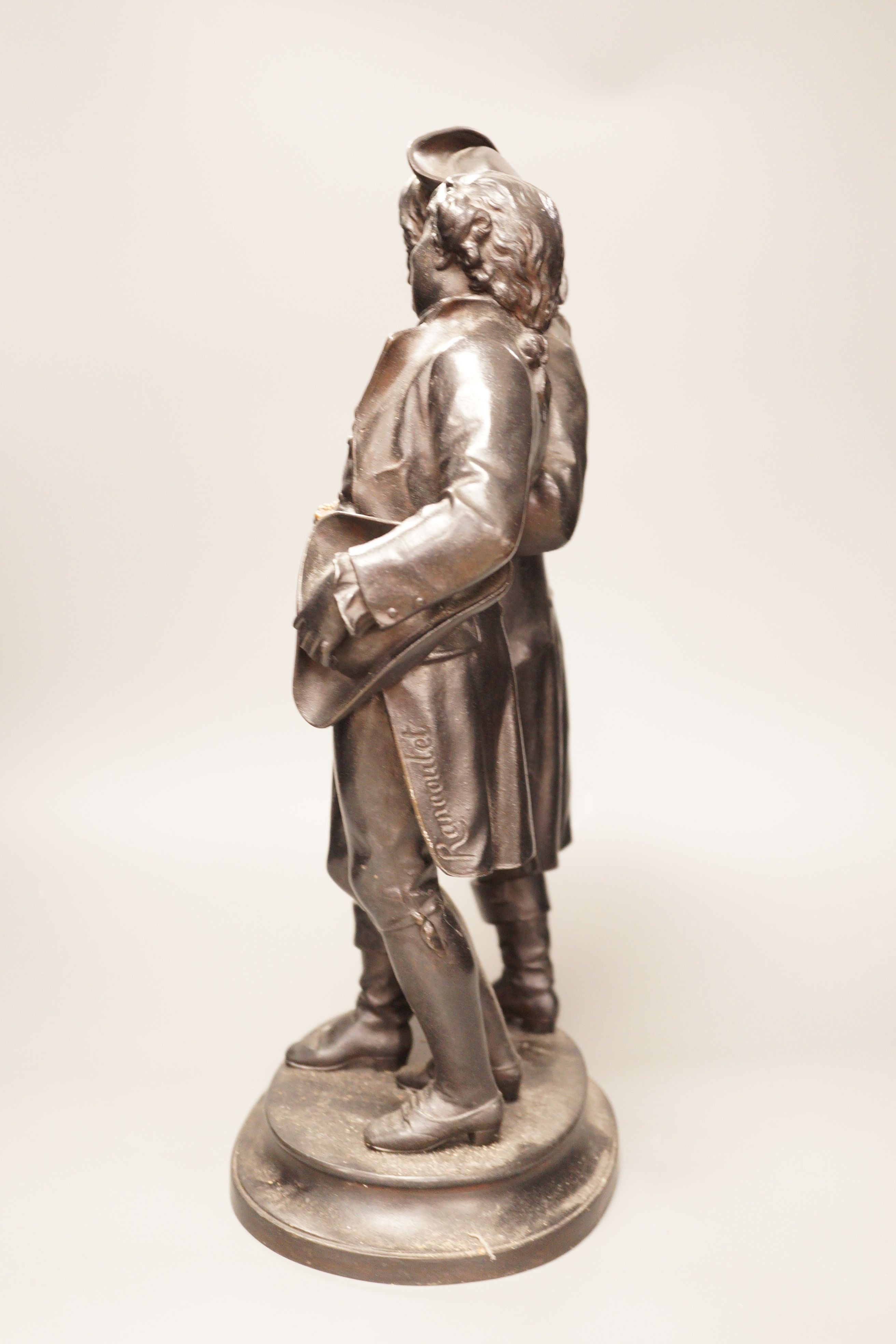 A black patinated spelter group, two 18th century figures in conversation, 48cm tall